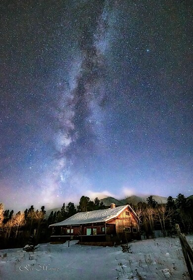 A wooden cabin under a starry night sky with the Milky Way visible. 5