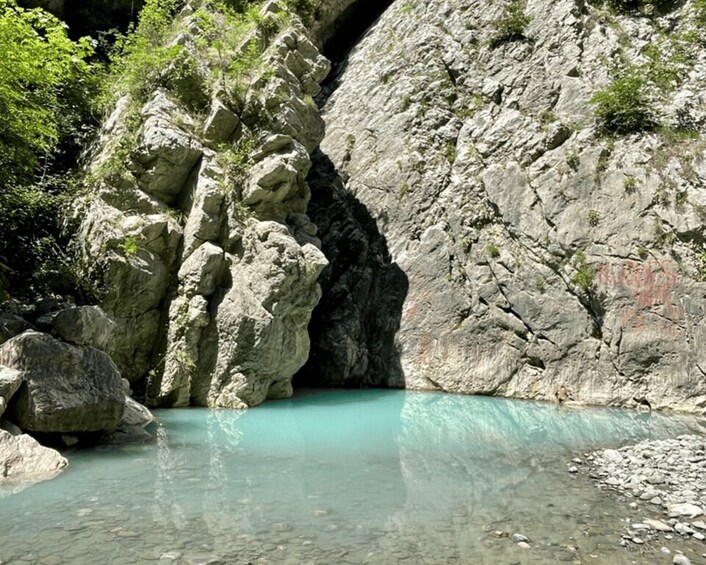 A rocky gorge with clear turquoise water and lush greenery. 2