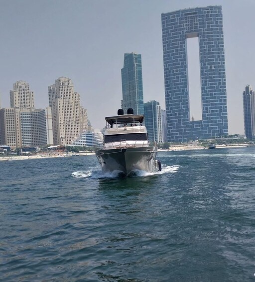 A boat moving through water with a city skyline in the background. 4