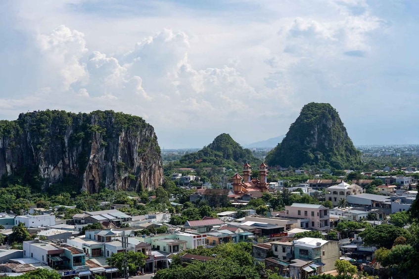 A town with buildings and two prominent limestone cliffs. 5