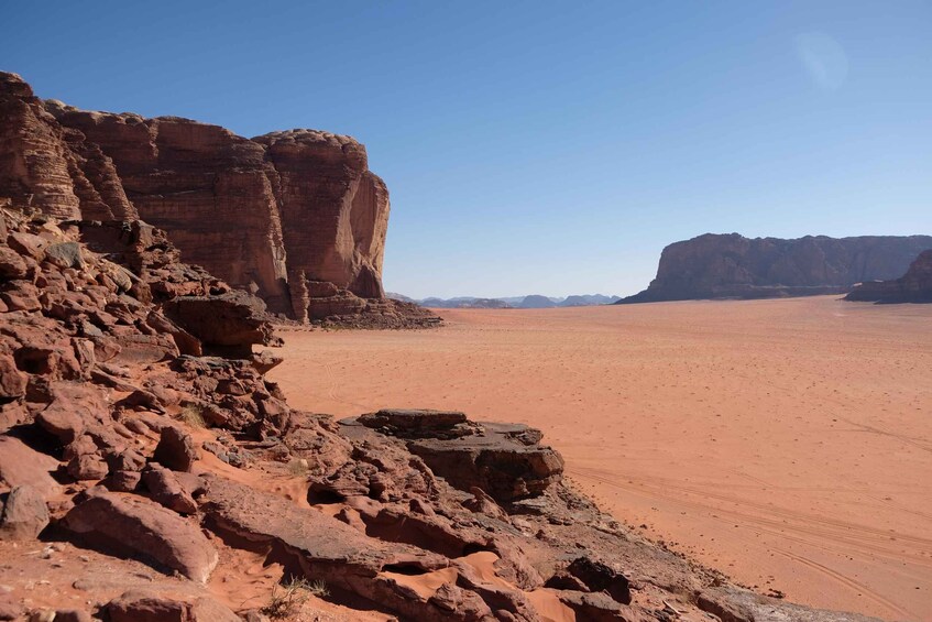 A desert landscape with red rock formations and a clear sky. 2