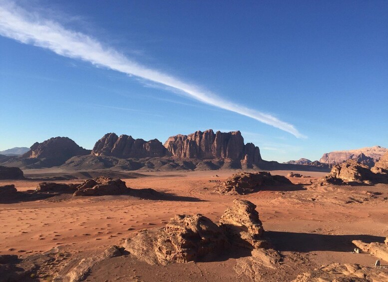 A desert landscape with prominent rock formations and a clear blue sky. 4