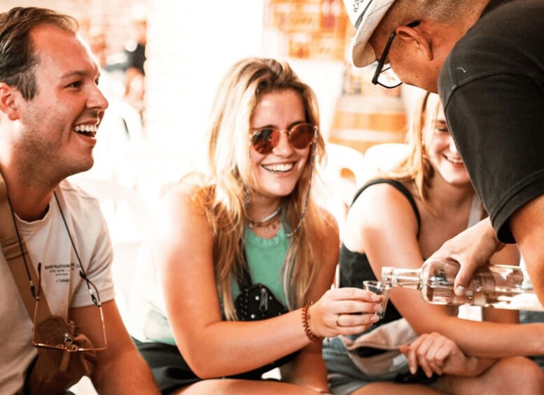 A group of people sitting at a table, engaged in conversation. 4