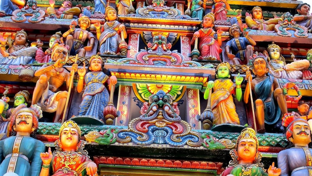 A colorful temple with multiple statues of deities and intricate carvings. 2
