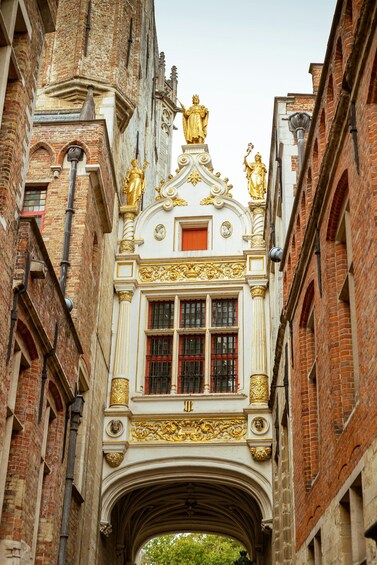 A historic building with ornate gold decorations and statues. 2