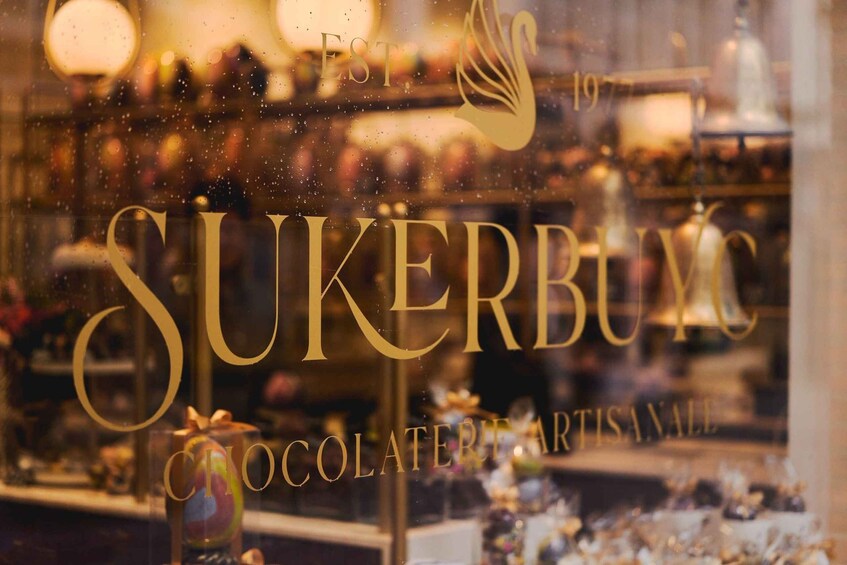 A shop window with the text 'SUKERBUM' and 'EST. 1977' indicating a chocolate shop. 5