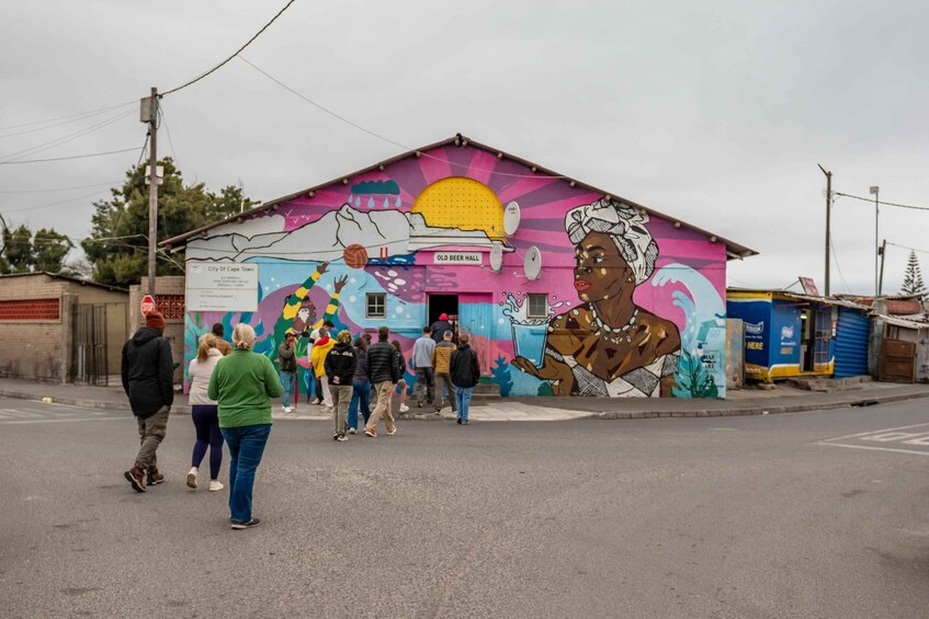 A colorful mural on a building with a sign reading "Old Beer Hall". 5