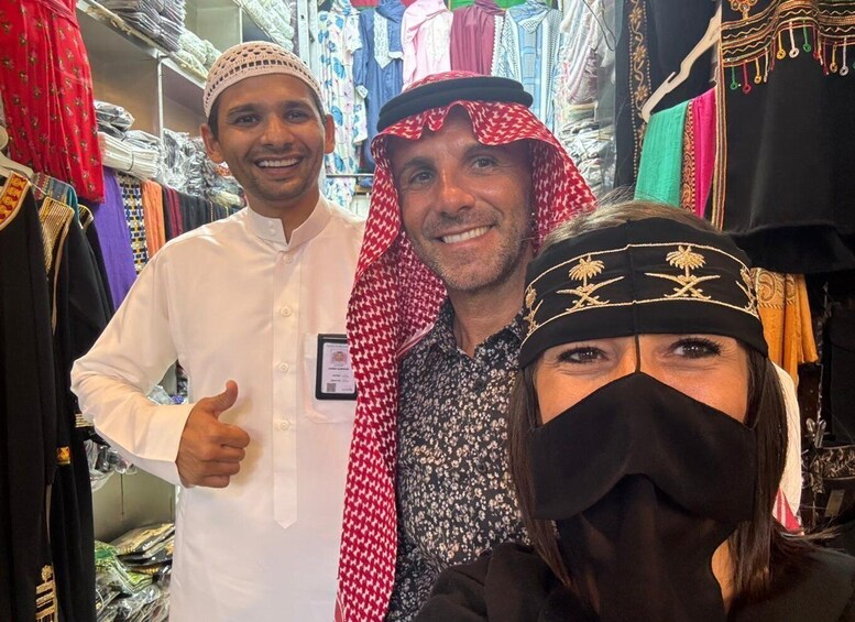 A market with various textiles and garments on display. 1
