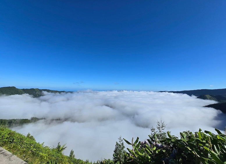 A mountain landscape with a sea of clouds below and a clear blue sky above. 2