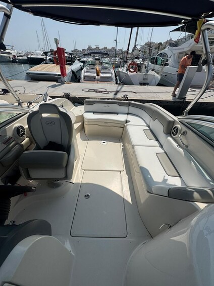 A boat's interior with seating and a steering wheel. 5