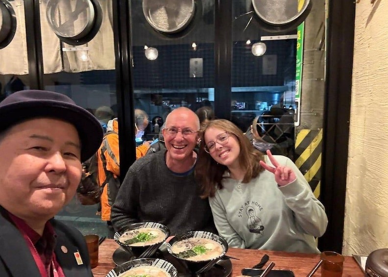 Three people sitting at a table with bowls of food, a window with reflections, and a door with a sign. 1