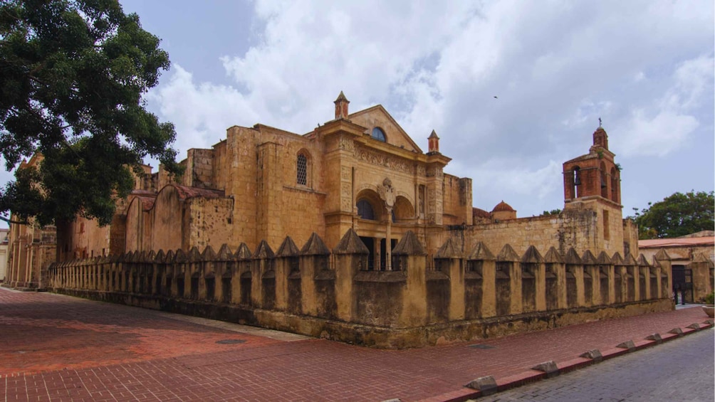 A historic church with a bell tower and a fortified wall. 3