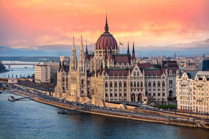 The Hungarian Parliament Building with a river in the foreground and a sunset in the background. 1