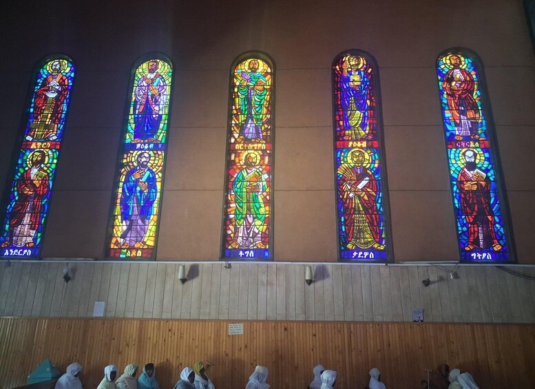 Five stained glass windows with religious figures. 2