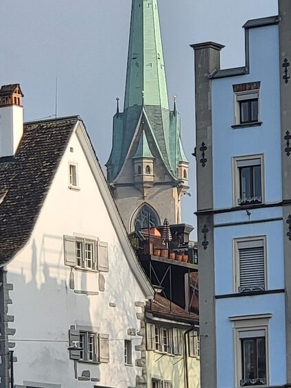 A historic building with a green spire and white walls. 4