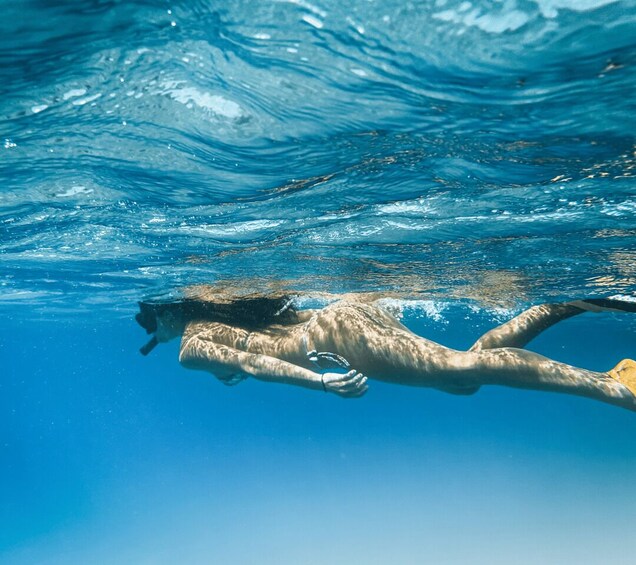 A person swimming underwater. 3
