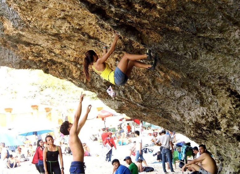 A person climbing a rock formation. 5