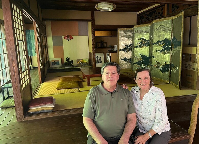 A traditional Japanese room with tatami flooring, a low wooden table, and a shoji screen. 4