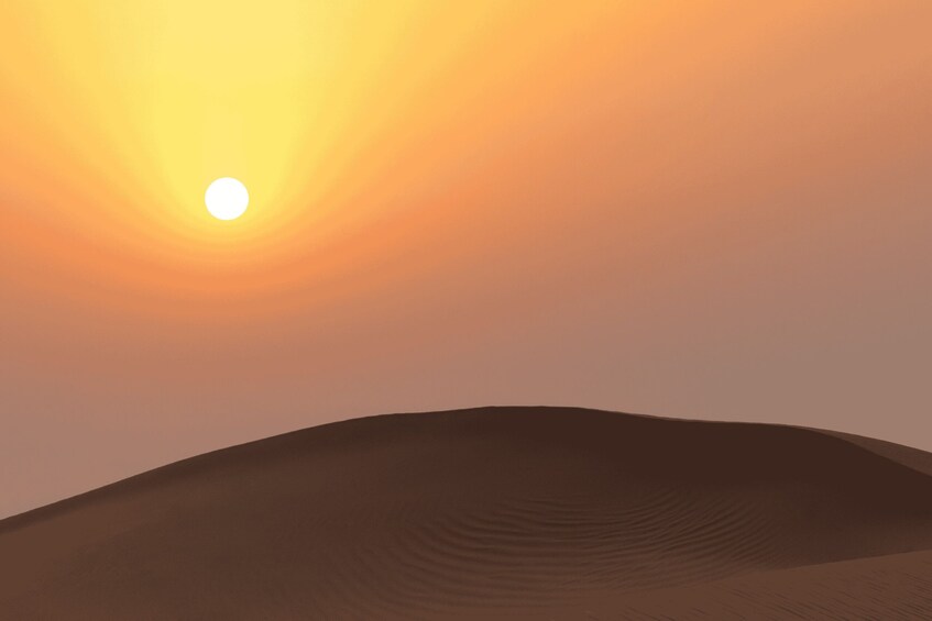 A desert landscape with sand dunes and a setting sun. 3