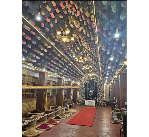 A room with a ceiling covered in hanging shoes. 3