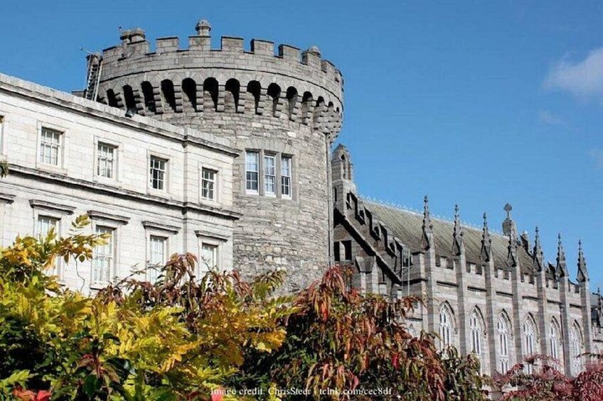 A castle with a round tower, arched windows, and a stone facade. 5