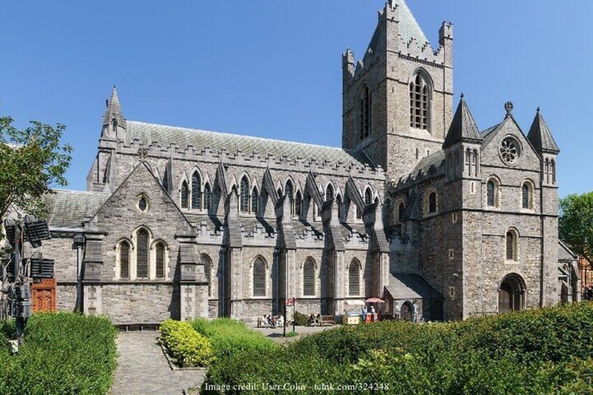 A historic stone church with a prominent tower and arched windows. 3