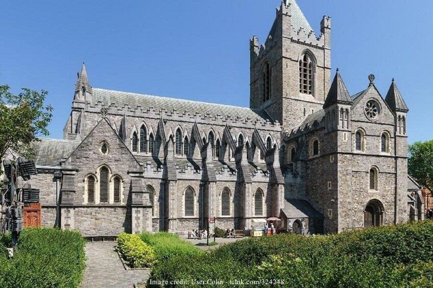 A historic stone church with pointed arches and a tall tower. 3