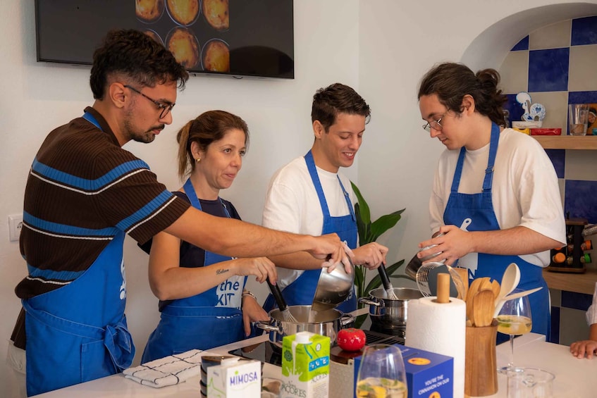 A group of people in a kitchen, preparing food. 3