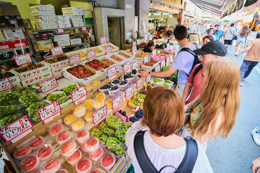 A bustling outdoor market with various fruits and vegetables on display. 2