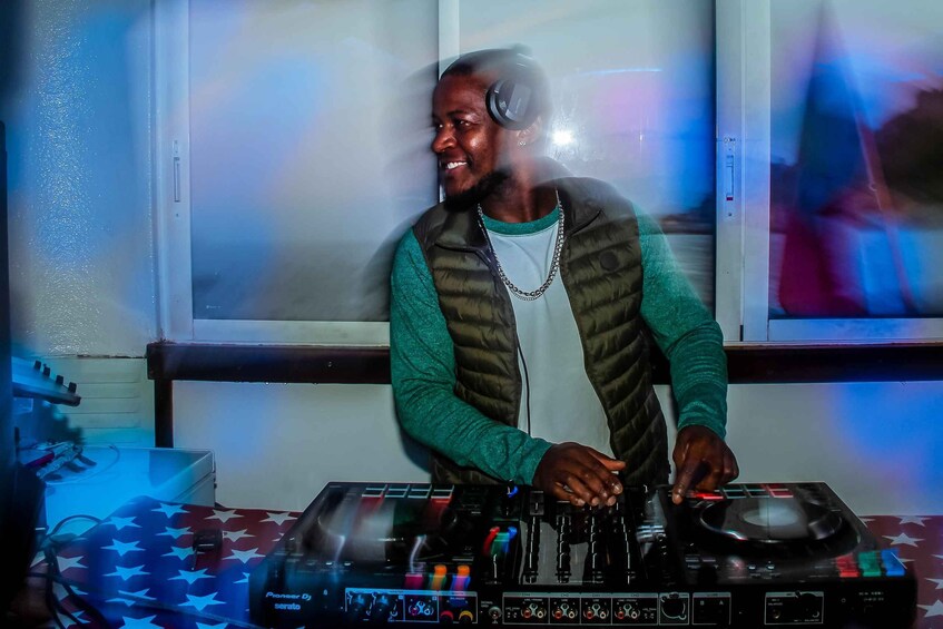 A person DJing with a Pioneer DJ serato controller. 2