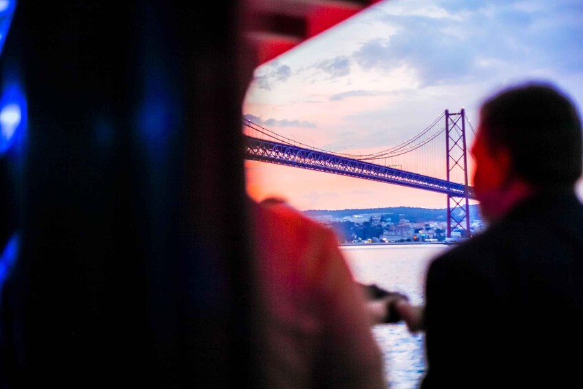 A person looking at a bridge from a window. 1