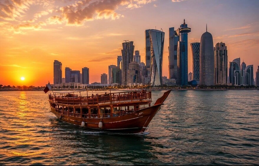 A traditional wooden boat on water with a modern city skyline in the background during sunset. 1