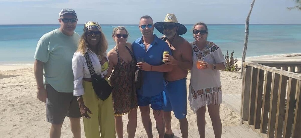 A group of people on a beach with the ocean in the background. 5