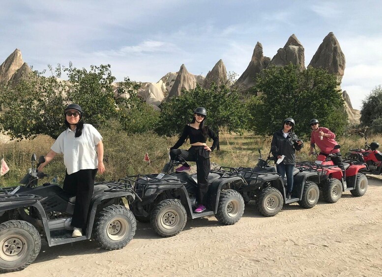 People on ATVs in a rocky outdoor setting. 4