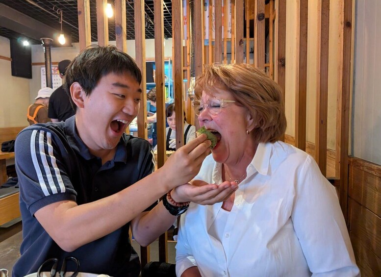 Two people eating at a restaurant with wooden paneling. 2
