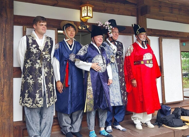 A group of people in traditional Japanese attire standing in a wooden building. 5