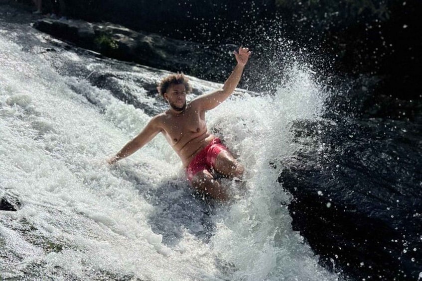 A person surfing a wave in a river. 1
