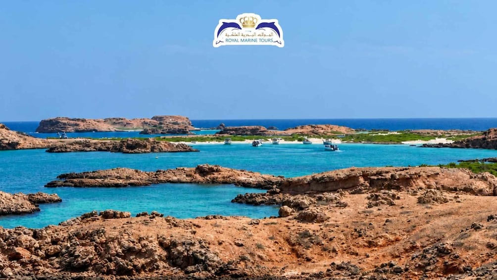 A coastal landscape with rocky terrain and clear blue waters. 5