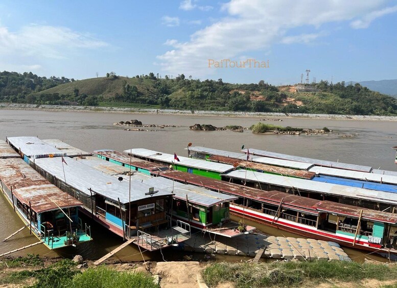 A river with several boats docked along the shore. 4