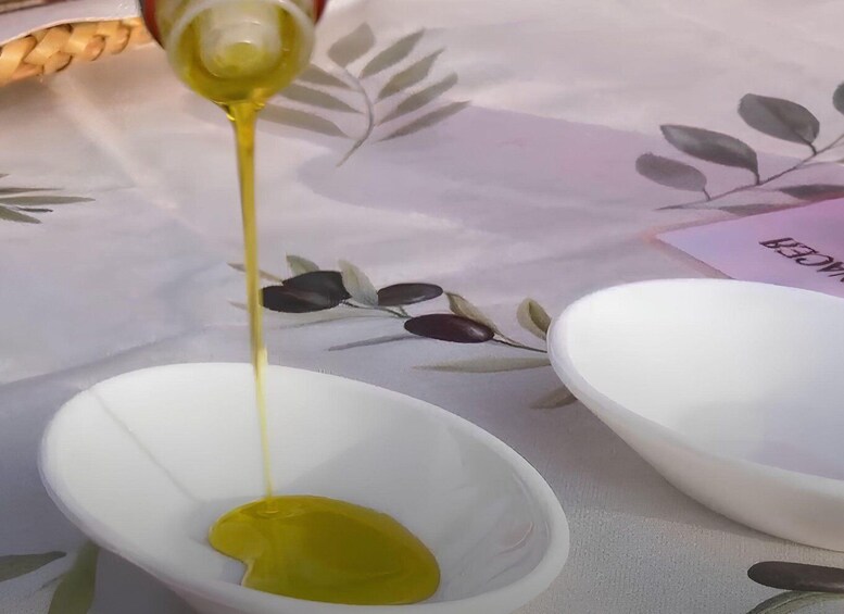 A white bowl with olive oil being poured into it. 4