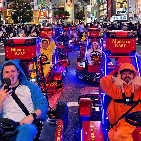 People riding Monster Kart vehicles in a busy urban street. 5