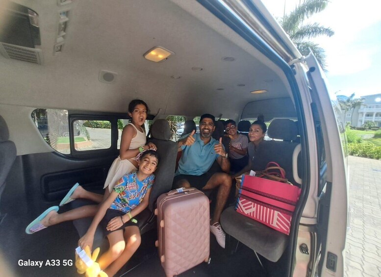 A family of five in a van with luggage. 3
