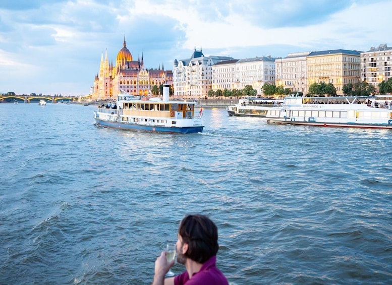 A river with boats, a large domed building, and a bridge in the background. 3