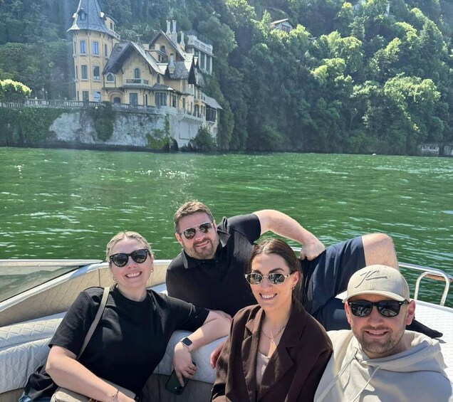 A group of people on a boat with a castle in the background. 5
