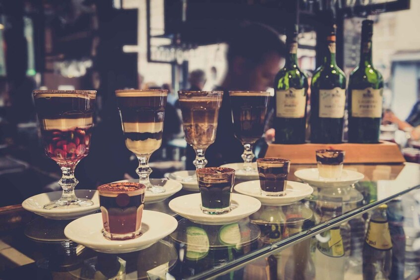 A bar counter with various drinks and bottles. 4