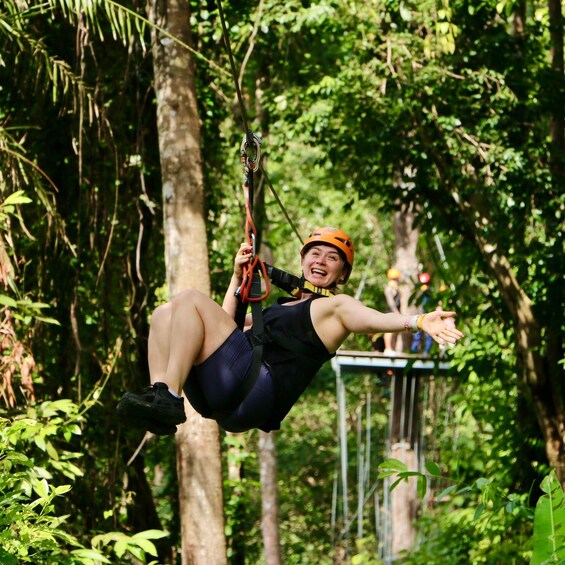 A person ziplining through a forest. 2