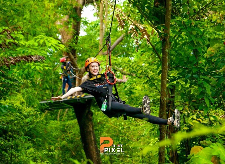 A person zip-lining through a lush forest. 5
