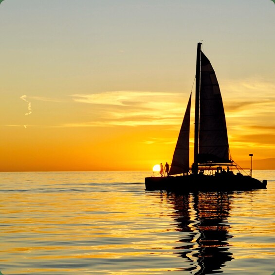 A sailboat on calm waters during sunset. 2