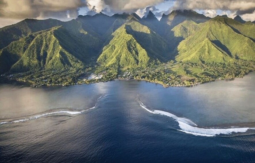 A coastal landscape with mountains and a calm sea. 5