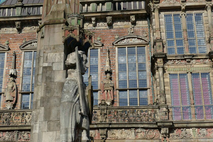 A detailed stone statue and ornate architectural elements of a historic building. 3